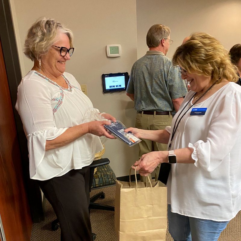 Executive director giving a volunteer a bag of goodies