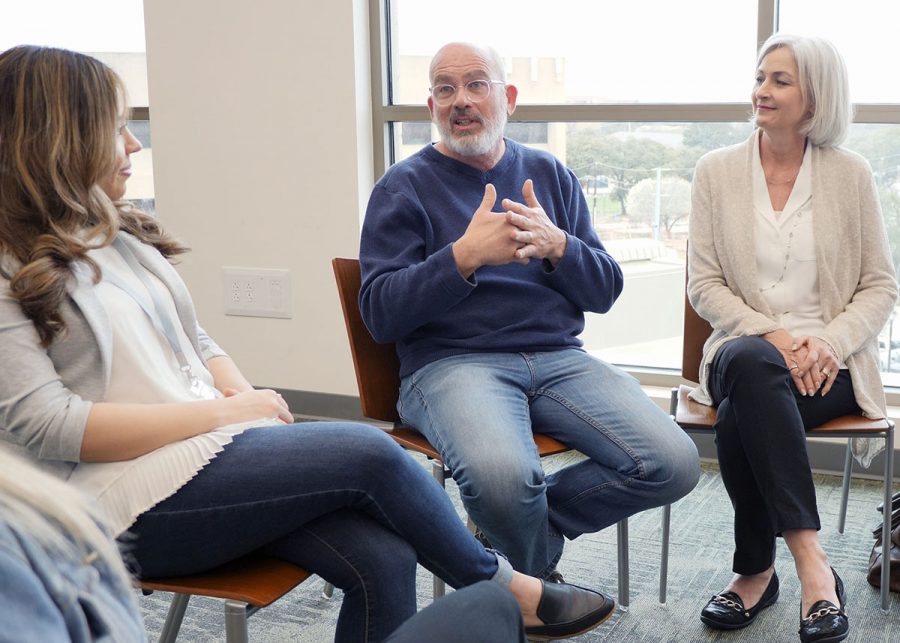 Middle-aged man in peer group talking