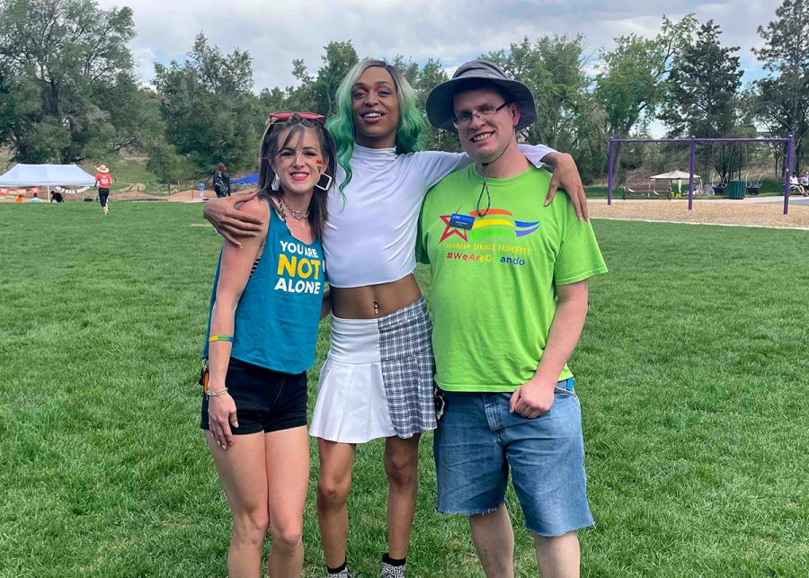 Three people posing for the camera at a NAMI pride event