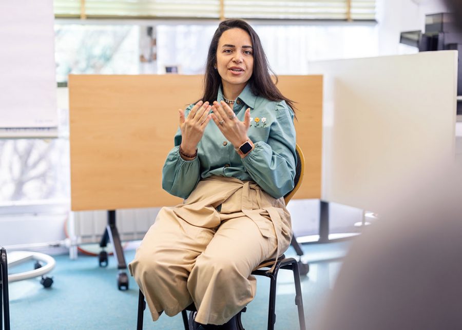 Person sharing their story in front of a group in a hospital