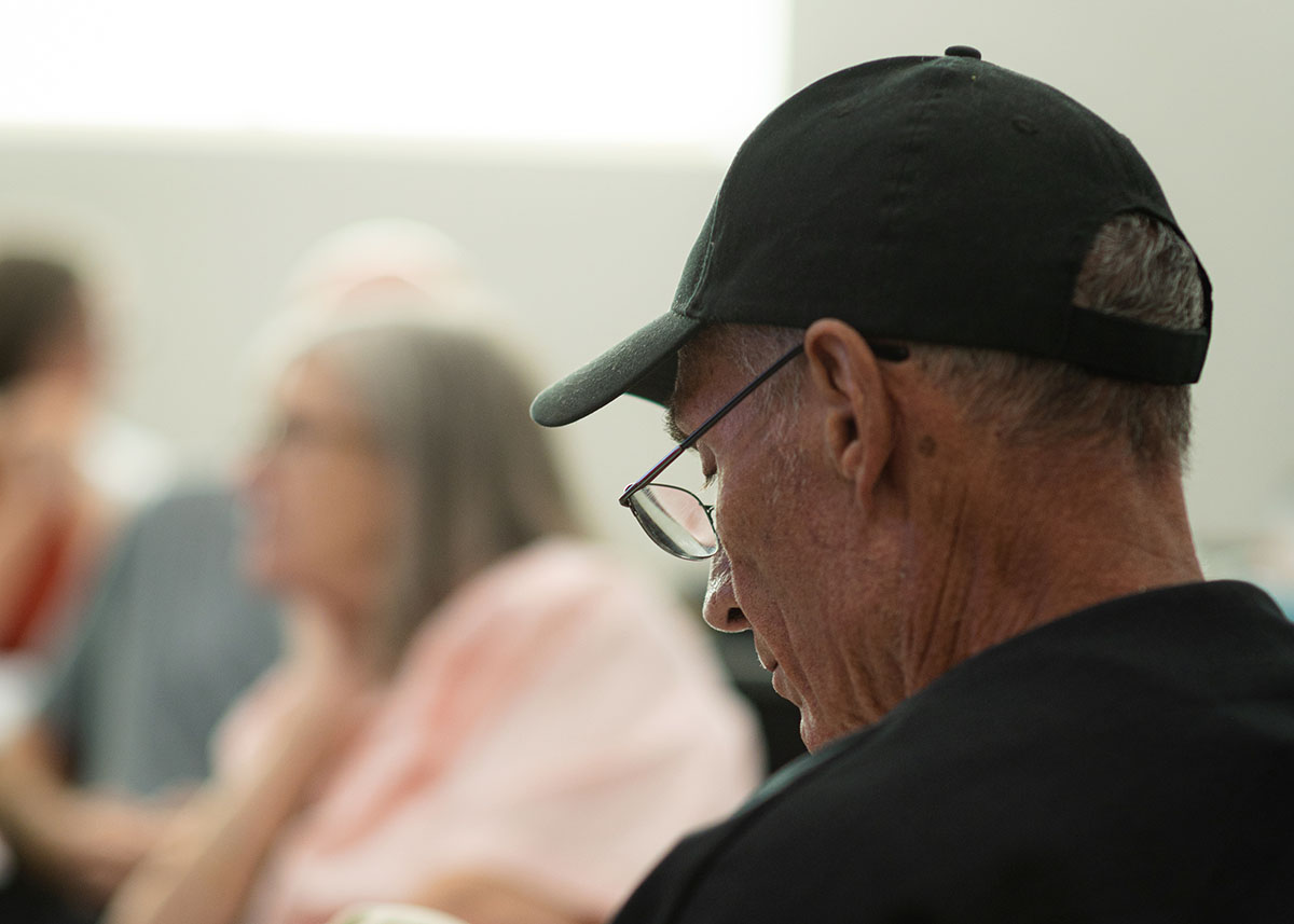 Man with hat listening in parents class