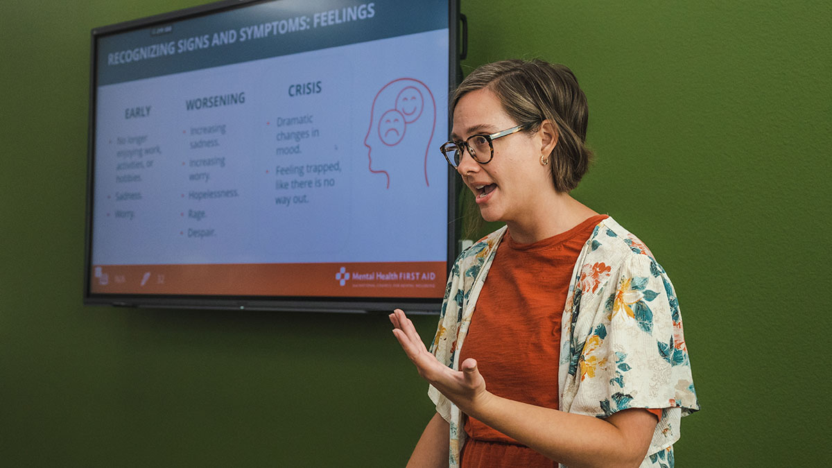 NAMI staff member presenting in front of a screen with resources