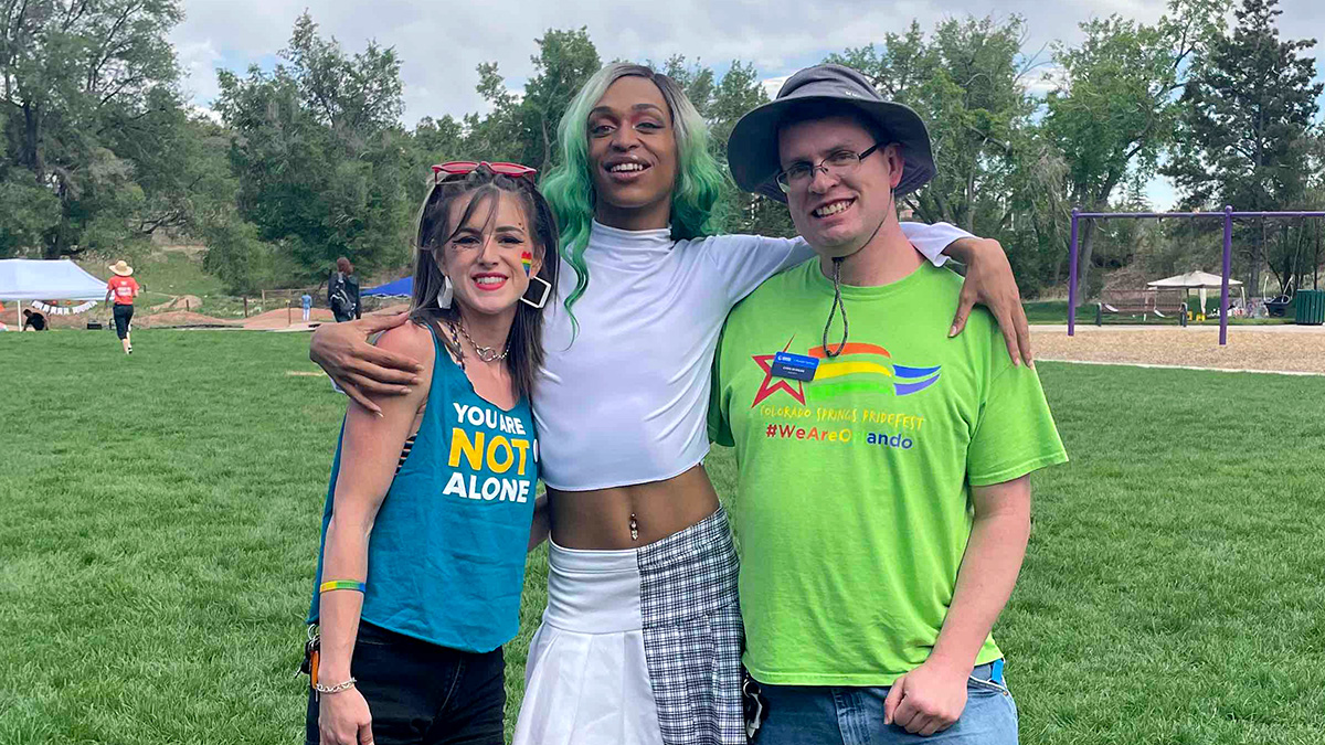 Three people posing for the camera at a NAMI pride event